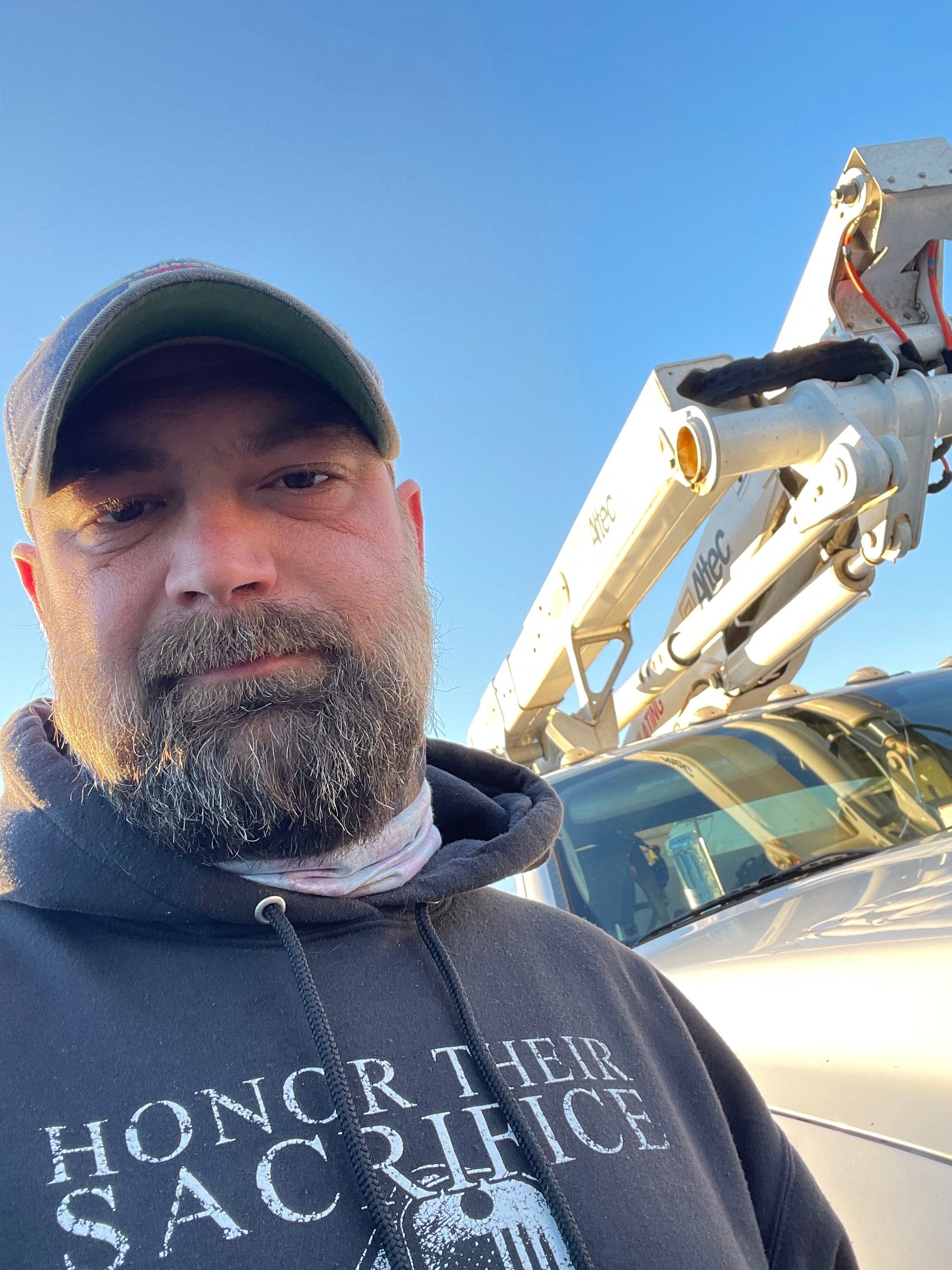 Justin Myers on a job site with bucket truck equipment
